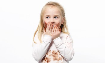 Girl playing with chocolate sauce